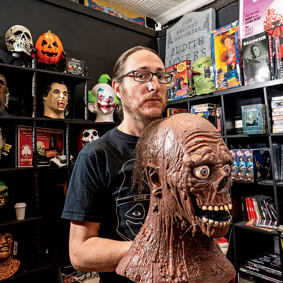 Ryan Graveface with various monster busts and collectibles at Graveface Records and Curiosities