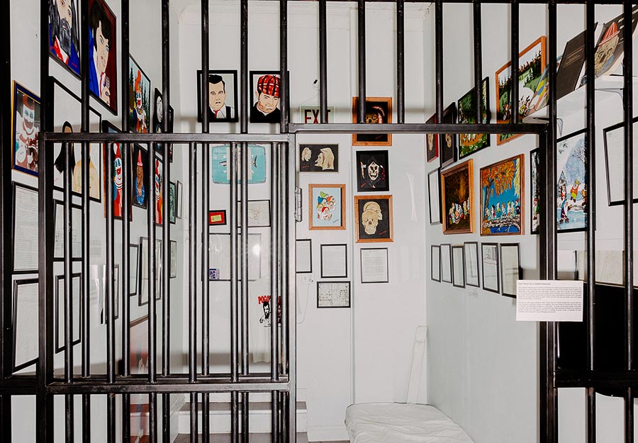 A display of art inside a recreation of John Wayne Gacy's jail cell at Graveface Records and Curiosities