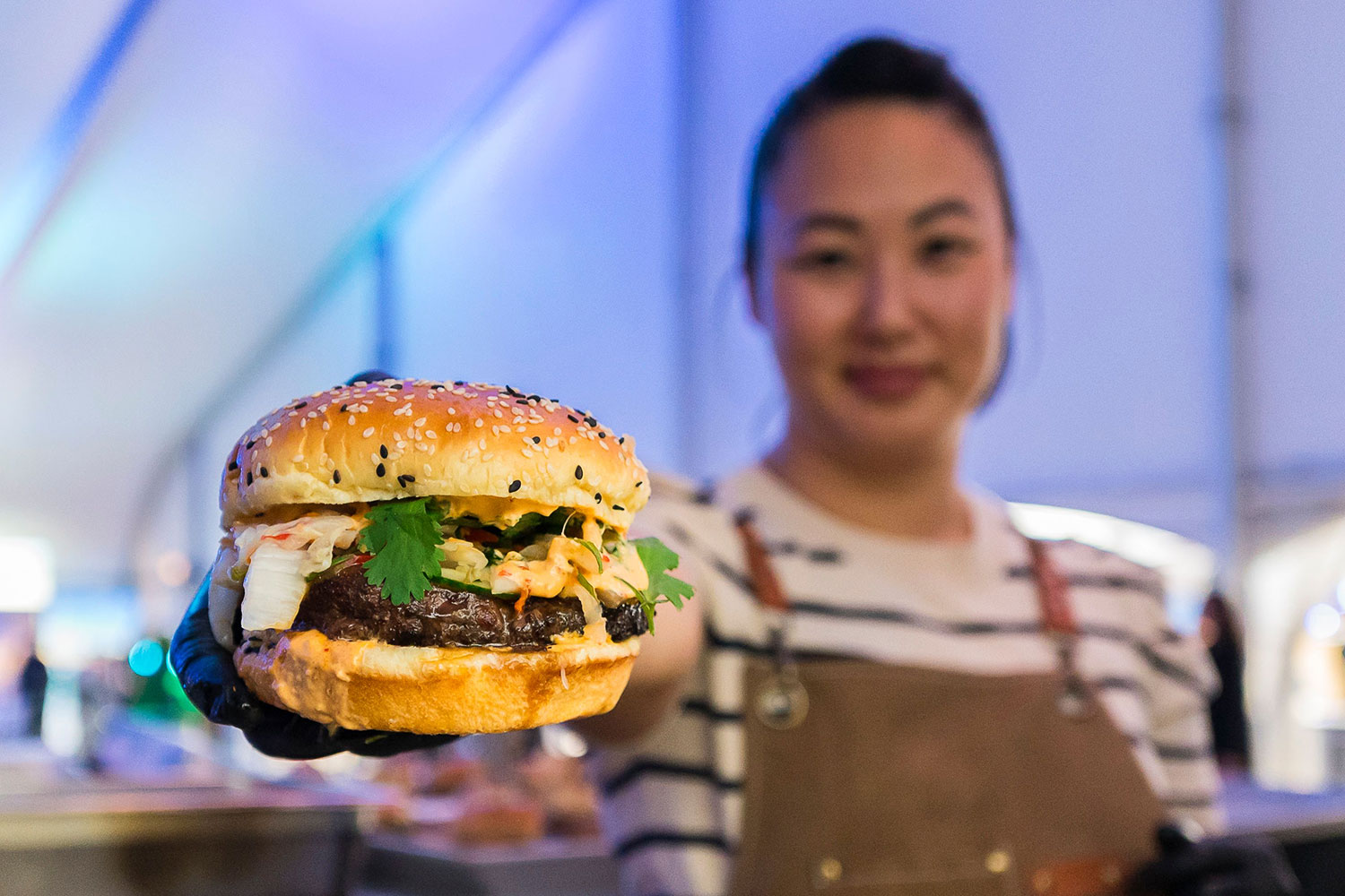 A chef holding a cheeseburger