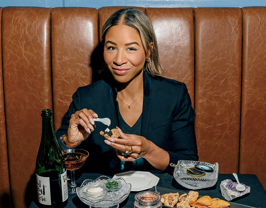 Kendra Anderson putting caviar on a cracker