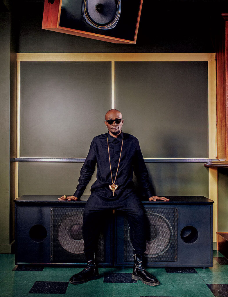 Isaiah Collier sitting on a pair of large speakers.